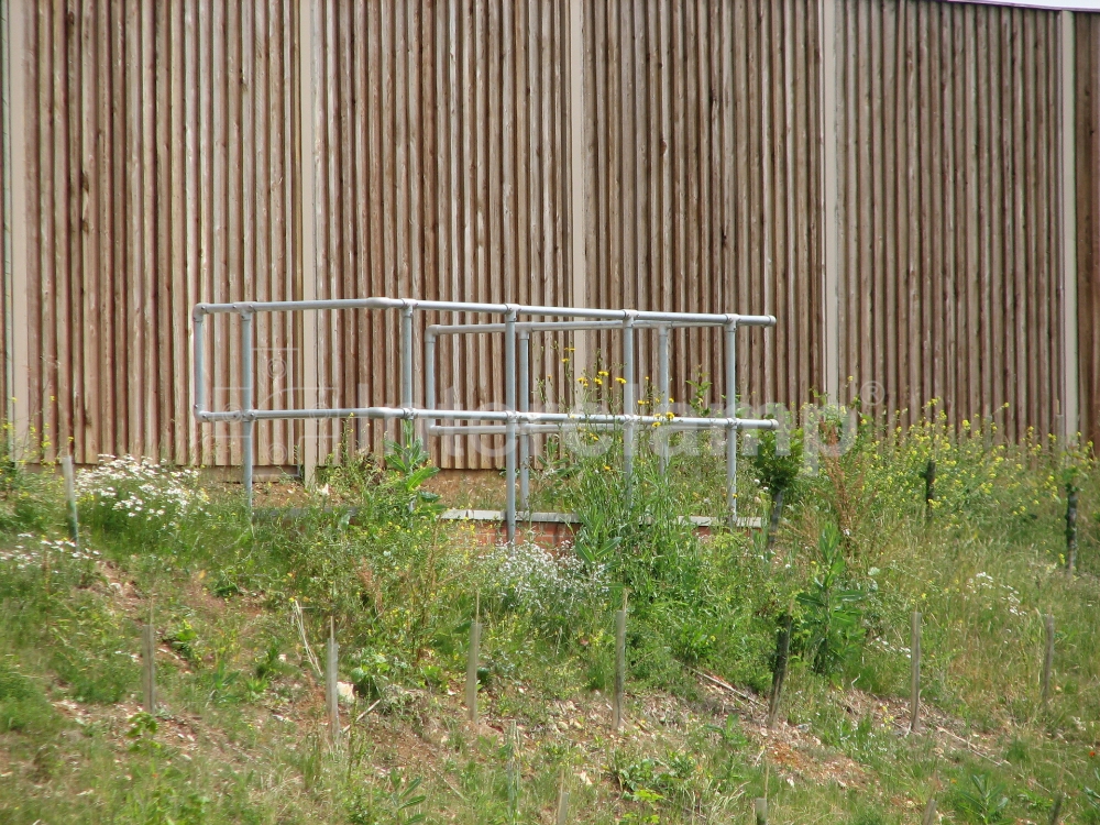 Interclamp standard safety stanchion posts used to create a safe pedestrian barrier along a bustling main road, enhancing public safety.